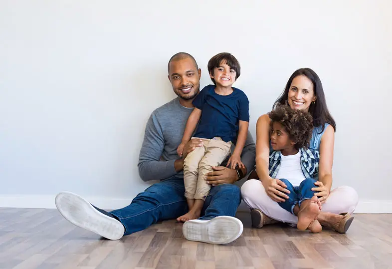 Family Matters - Mixed Race Family Setting On Hardwood Floor